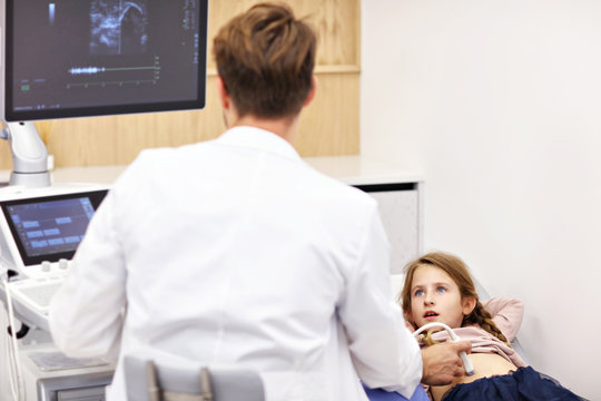 Doctor testing young girl with usg