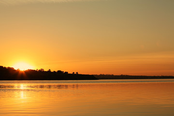 Fototapeta na wymiar Picturesque view of beautiful sunset on riverside