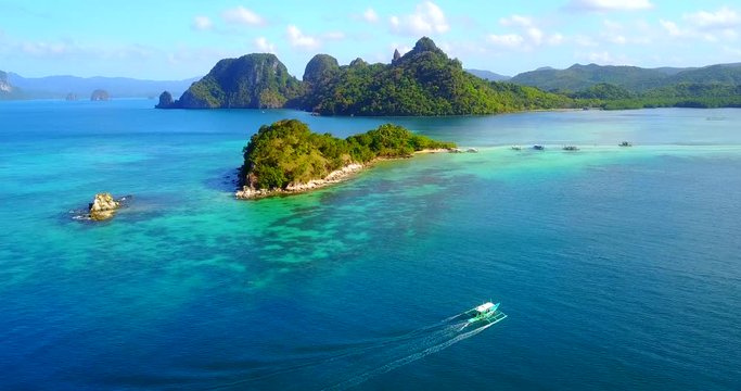Dramatic Aerial View Of El Nido Islands With Catamaran-Style Boat Traversing In Foreground - Palawan, Philippines