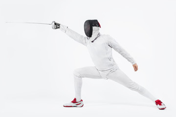 Fototapeta na wymiar Young fencer athlete wearing mask and white fencing costume. holding the sword. Isolated on white background