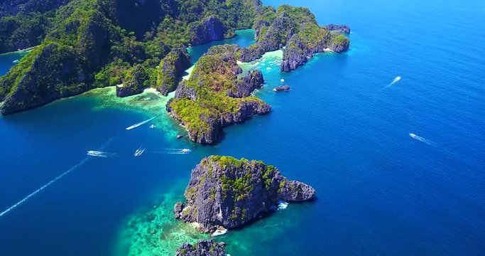 El Nido Tropical Islands With Multiple Boats Moving On The Coastal Waters - Palawan, Philippines - Aerial View