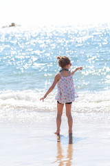 little girl playing on the beach