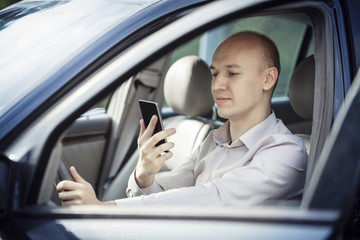 Businessman driving and talking on phone