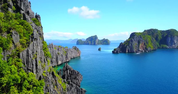 Dramatic Fly-By Of Rocky Ocean Cliffs - El Nido, Palawan, Philippines - Aerial View