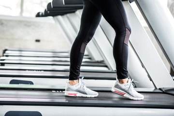 Fototapeta na wymiar Asian woman on treadmill in the gym