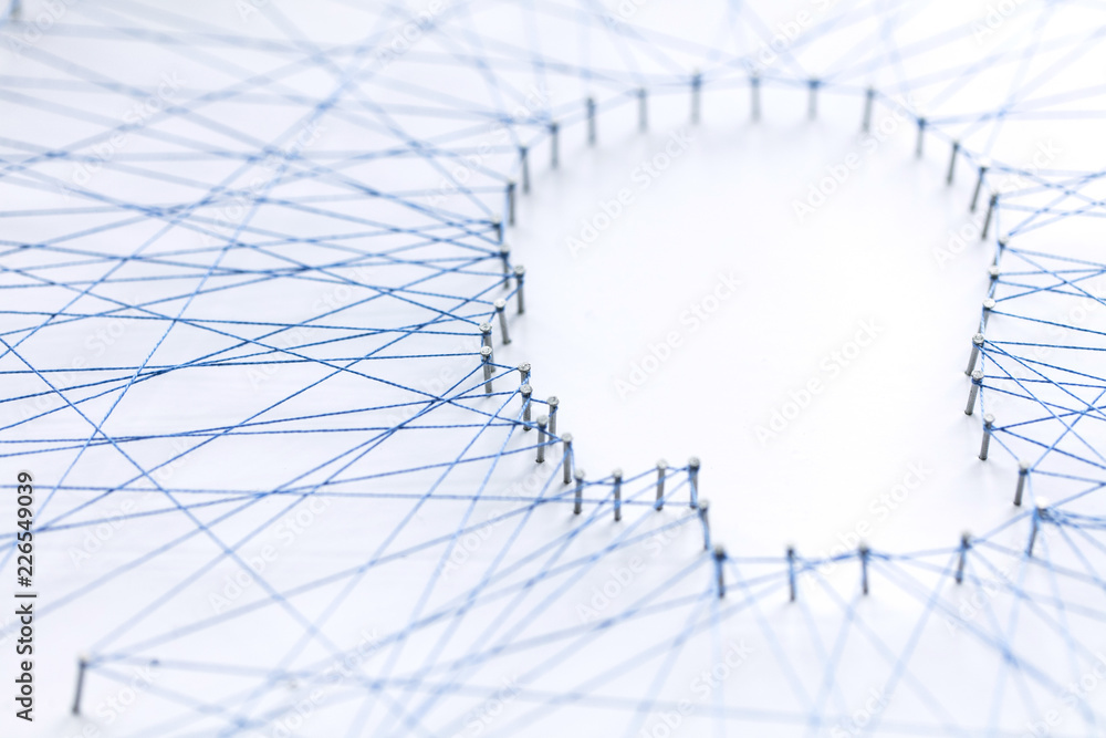 Poster human head shape made from a large grid of pins connected with string. communication technology and 