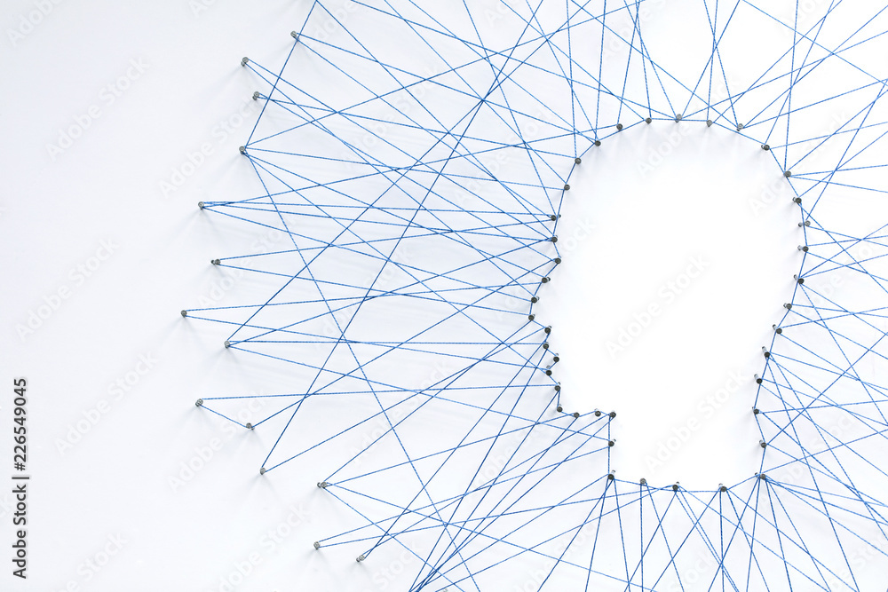 Poster human head shape made from a large grid of pins connected with string. communication technology and 