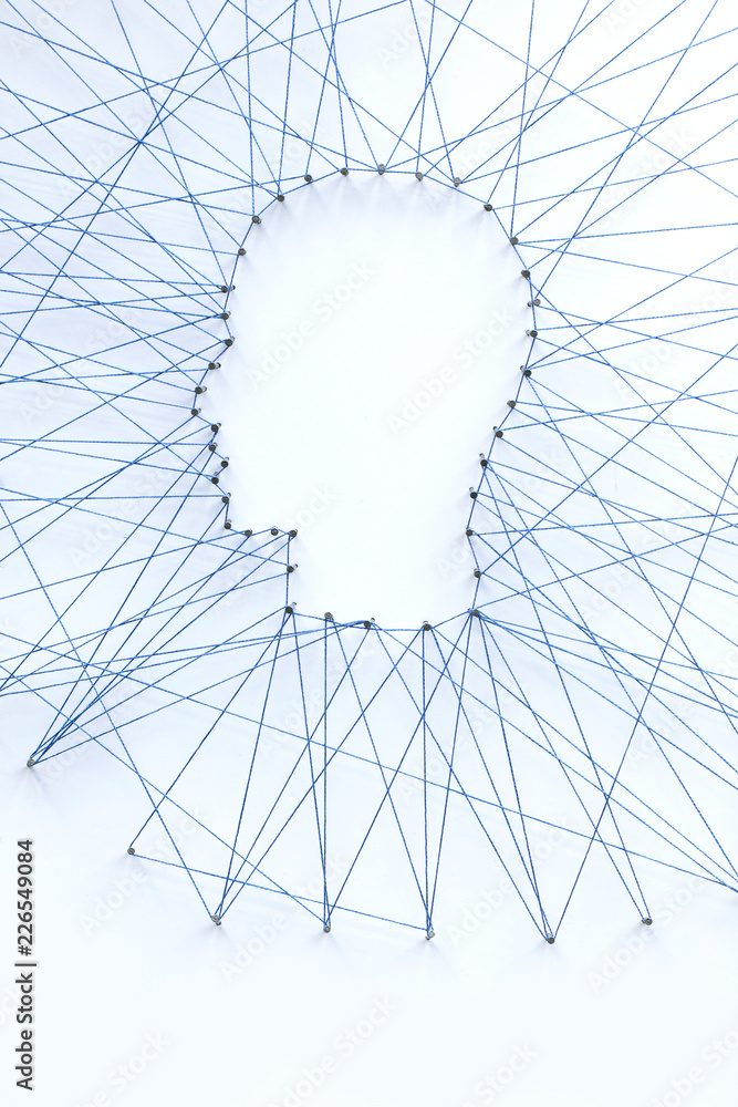 Poster human head shape made from a large grid of pins connected with string. communication technology and 