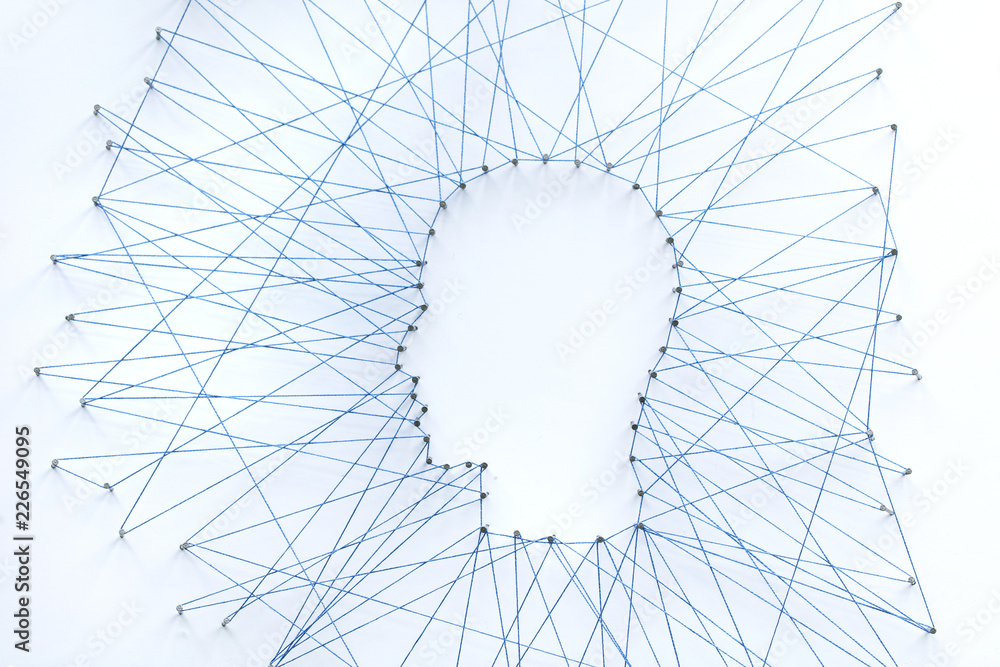 Poster human head shape made from a large grid of pins connected with string. communication technology and 