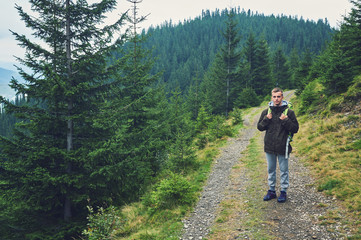 Obraz premium tourist on the road in the mountains