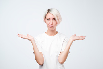 Pretty european girl with short hairstyle do not know what to do