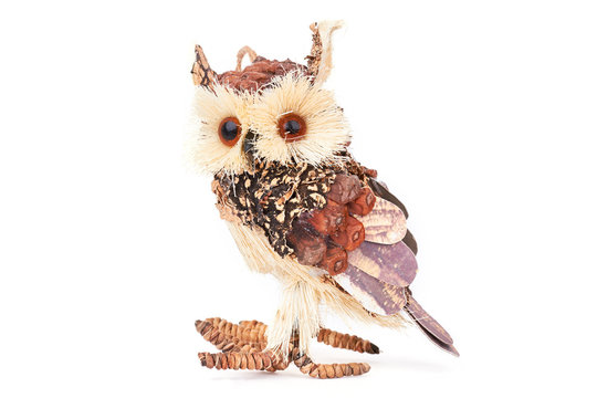 Handmade wooden owl on white background. Beautiful handicraft owl made from wood isolated on white background. Cute handmade gift.