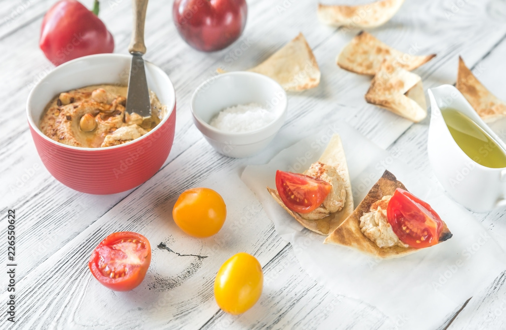 Poster bowl of hummus with and tortilla chips