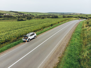 woman stuck with broken car in the middle of nowhere.