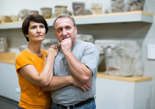 Positive man and woman looking at sculptures