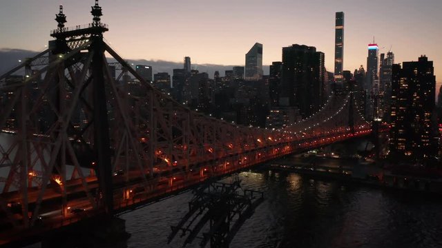 dusk flying along Queensboro Bridge towards Manhattan
