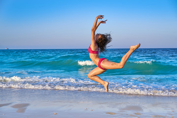 acrobatic gymnastics bikini girl in a beach