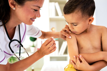 Gentle lady doctor giving a vaccine