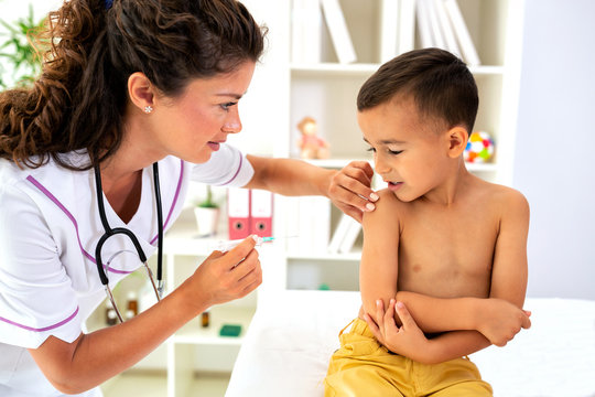 Pediatrician giving child a vaccine