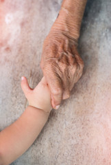 Elderly hands are holding hands baby.