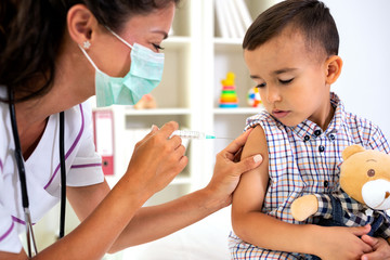 Little brave man receiving a vaccine - obrazy, fototapety, plakaty