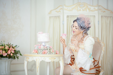Fototapeta na wymiar Beautiful greyhead woman in Rococo dress posing in front of historic background while eating cake