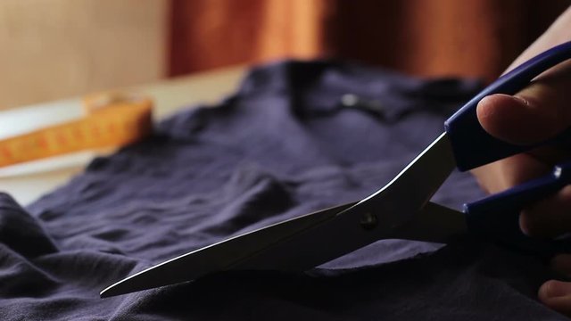 Tailor. Man Hands notch tailor tailor's scissors cloth. Close Up