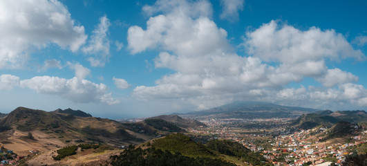 Fototapeta na wymiar rural landscape panorama with town / village in valley and summer sky on sunny day, Tenerife, Spain