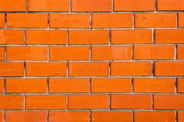 A wall of red facing bricks. Background and texture