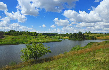 Fototapeta na wymiar Sunny summer landscape with fields,river and beautiful woods.Tula region,Russia
