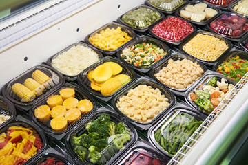 Chilled vegetables in plastic on shop counter