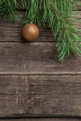 Obraz na płótnie Canvas Yellow Christmas ball on wooden background