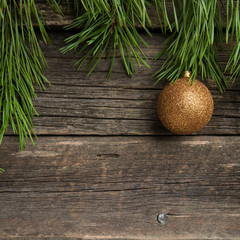 Yellow Christmas ball on wooden background