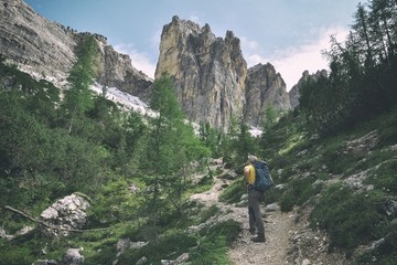 Tourist hiking in Dolomites mountains 