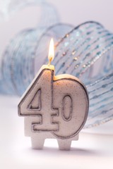 lit number candles with a ribbon