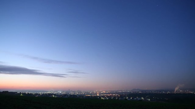 Time lapse overlooking a rural town. Lights change as the city goes from late evening to night.