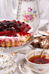 Sweet cake with cherry jelly, tasty and fresh. Antique tea set