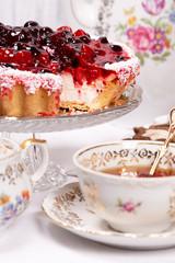 Sweet cake with cherry jelly, tasty and fresh. Antique tea set
