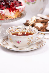 Sweet cake with cherry jelly, tasty and fresh. Antique tea set