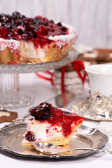 Sweet cake with cherry jelly, tasty and fresh. Antique dishes