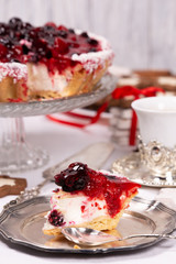 Sweet cake with cherry jelly, tasty and fresh. Antique dishes