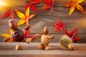 autumn tinker figures on wooden background - obrazy, fototapety, plakaty