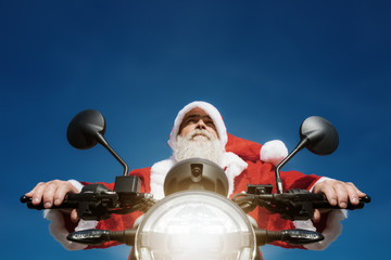 man on a motorbike in a typical Santa Claus costume