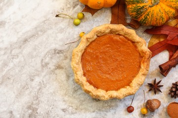 Homemade Pumpkin Pie on Fall Thanksgiving background, top view