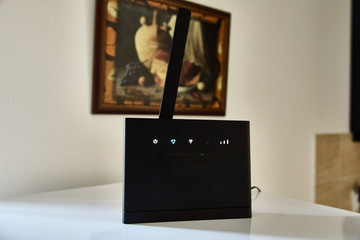 Black Wi-Fi router with one antenna. Internet in the apartment