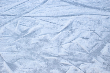 Ice rink surface abstract background with trace of skates