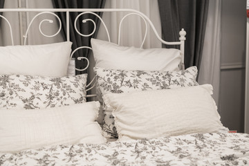 Gray pillows setting on grey and white color scheme bedding