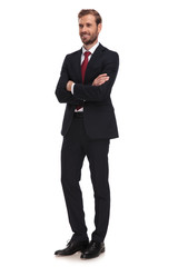 Obraz na płótnie Canvas attractive businessman standing with arms crossed looks to side