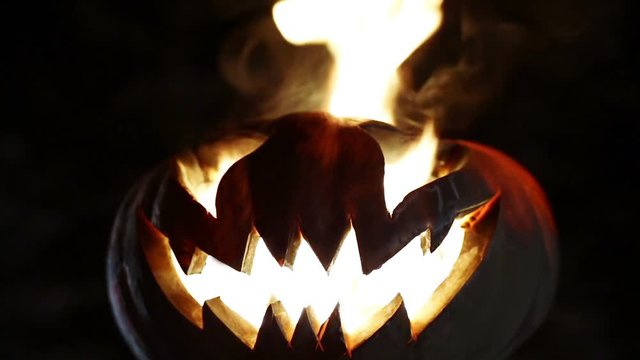 Burning smile pumpkin on Halloween. Looped