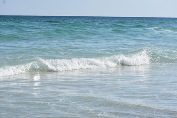 Gentle waves breaking on the beach